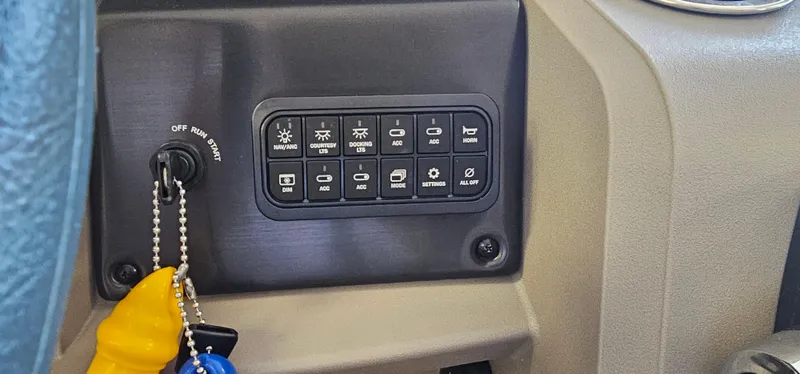 Slide: The Image of Control panel of 2024 Sun Tracker Party Barge 20 DLX with ignition switch and keychain. - 16