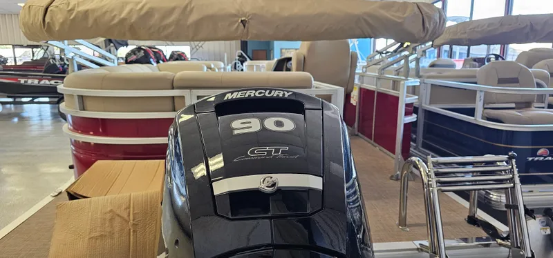 Slide: The Image of 2024 Sun Tracker Party Barge 20 DLX with Mercury 90 engine in showroom. - 2