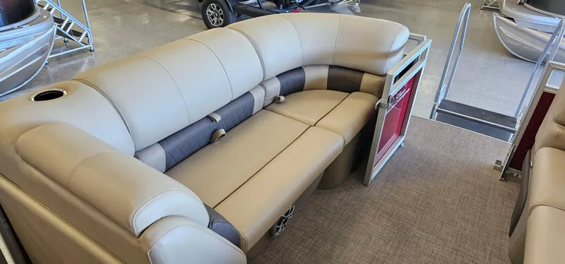 Slide: The Image of 2024 Sun Tracker Party Barge 20 DLX interior with beige seating and cup holder. - 7