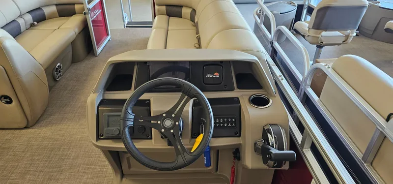Slide: The Image of 2024 Sun Tracker Party Barge 20 DLX interior with steering console and seating. - 9