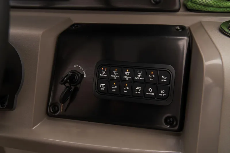 Slide: The Image of Control panel of 2024 Sun Tracker SportFish 22 DLX boat with various switches and ignition key. - 40