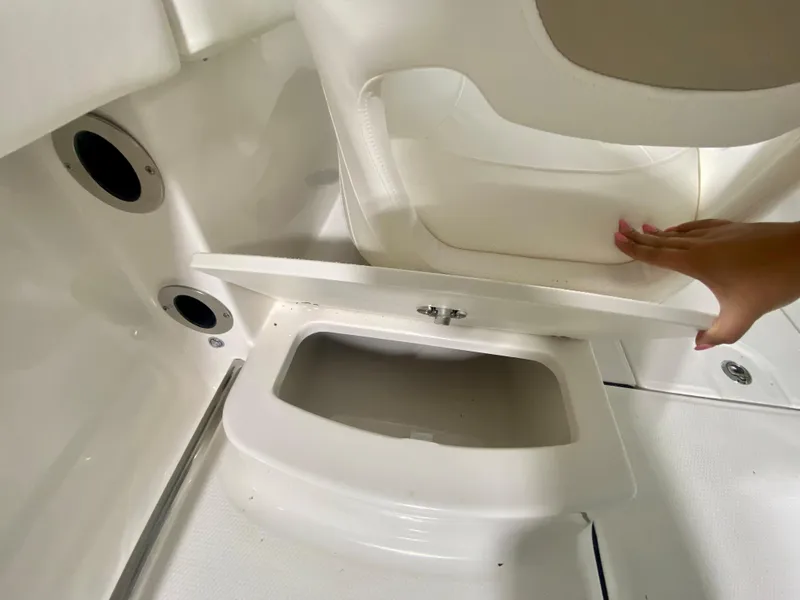 Slide: The Image of 2024 Robalo R207 Dual Console storage compartment with white interior. - 10