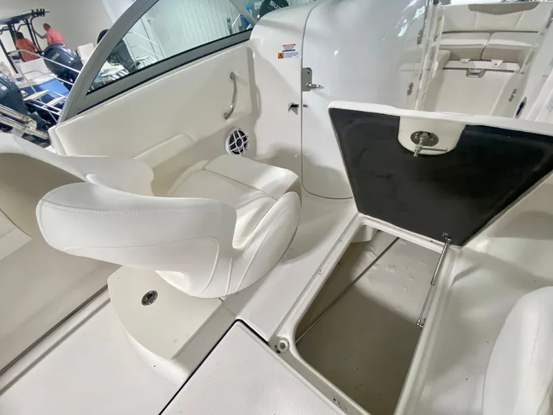 Slide: The Image of 2024 Robalo R207 Dual Console interior with white seating and storage compartments. - 13