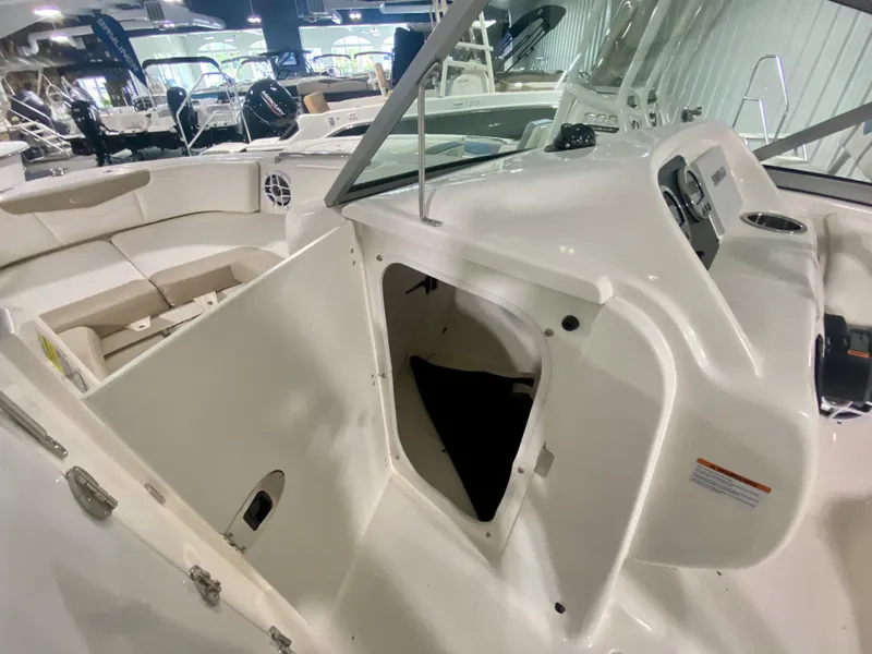 Slide: The Image of 2024 Robalo R207 Dual Console boat interior with open storage compartment. - 21