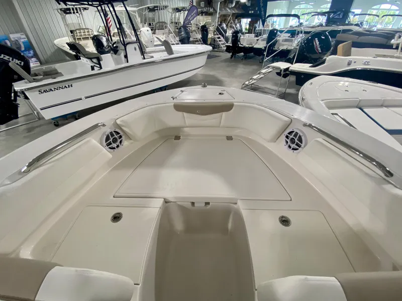 Slide: The Image of 2024 Robalo R207 Dual Console boat interior at a showroom. - 25