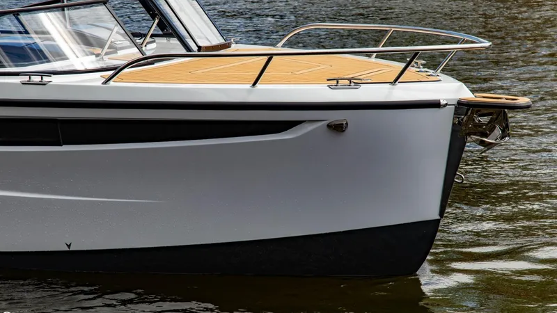Slide: The Image of 2023 Alfastreet 23 Cabin Electric boat on water, close-up of bow and deck. - 2