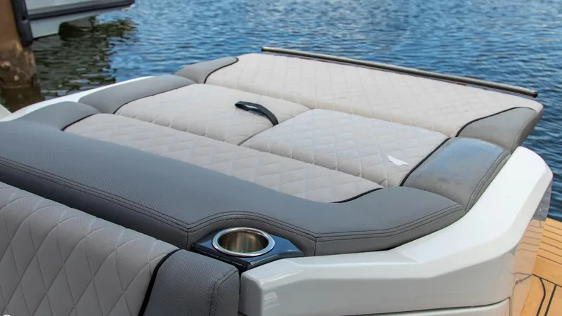 Slide: The Image of 2023 Alfastreet 23 Cabin Electric boat with luxurious seating and cup holder by the water. - 32