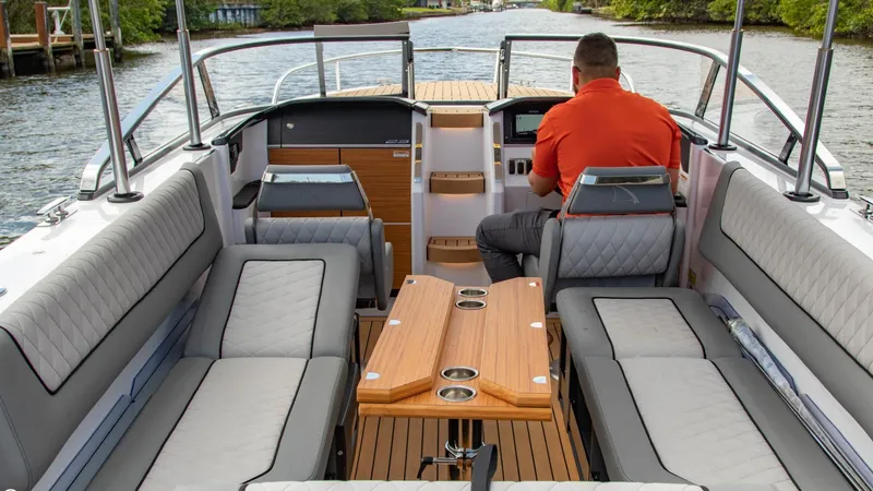 Slide: The Image of 2023 Alfastreet 23 Cabin Electric boat interior with seating and wooden table. - 40