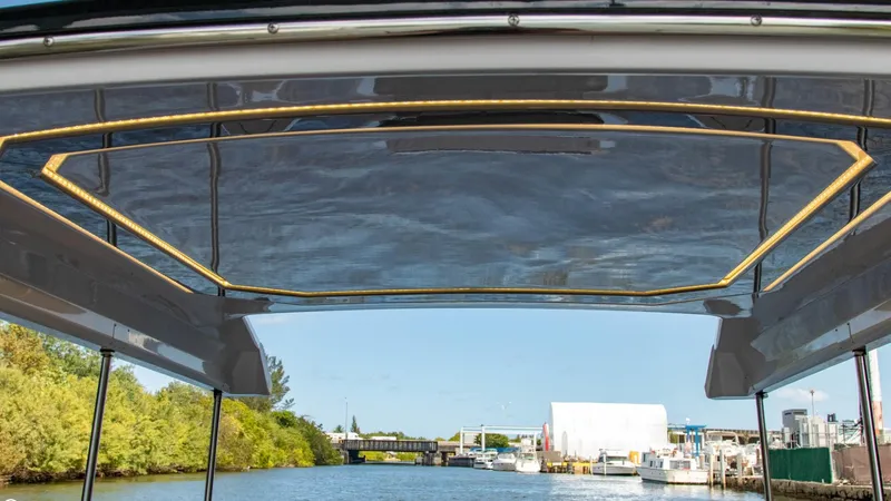 Slide: The Image of View from Alfastreet 23 Cabin Electric boat, 2023 model, showing waterway and marina. - 47