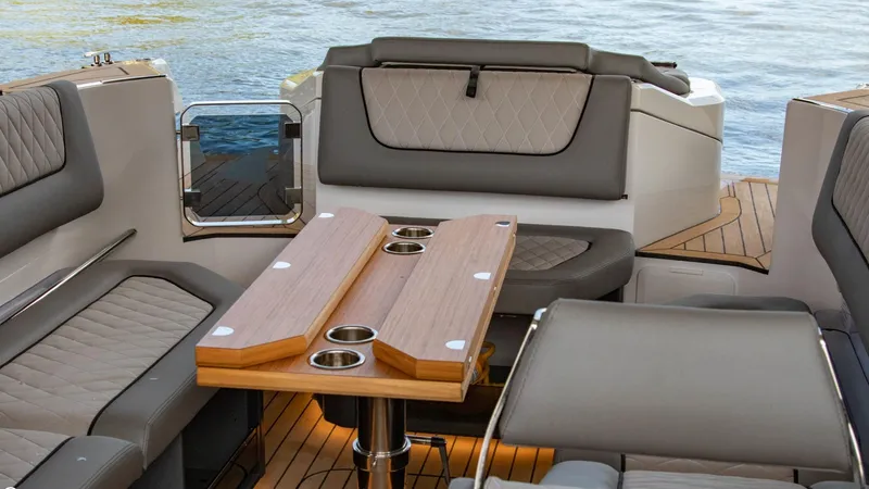 Slide: The Image of 2023 Alfastreet 23 Cabin Electric boat interior with seating and wooden table. - 48