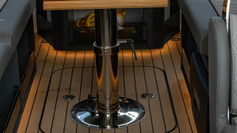 Slide: The Image of Interior of 2023 Alfastreet 23 Cabin Electric boat with wooden flooring and central table. - 49