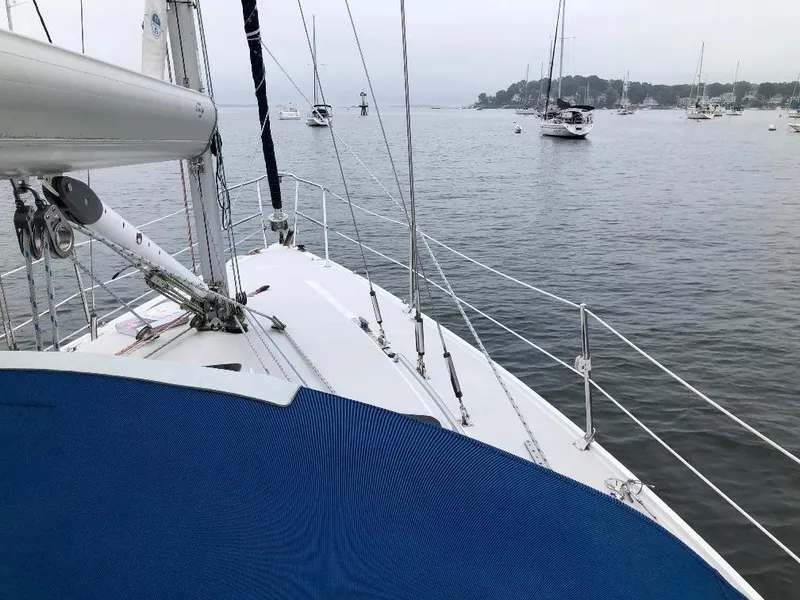 Slide: The Image of Deck of a 1998 Catalina 320 sailboat on calm waters. - 12