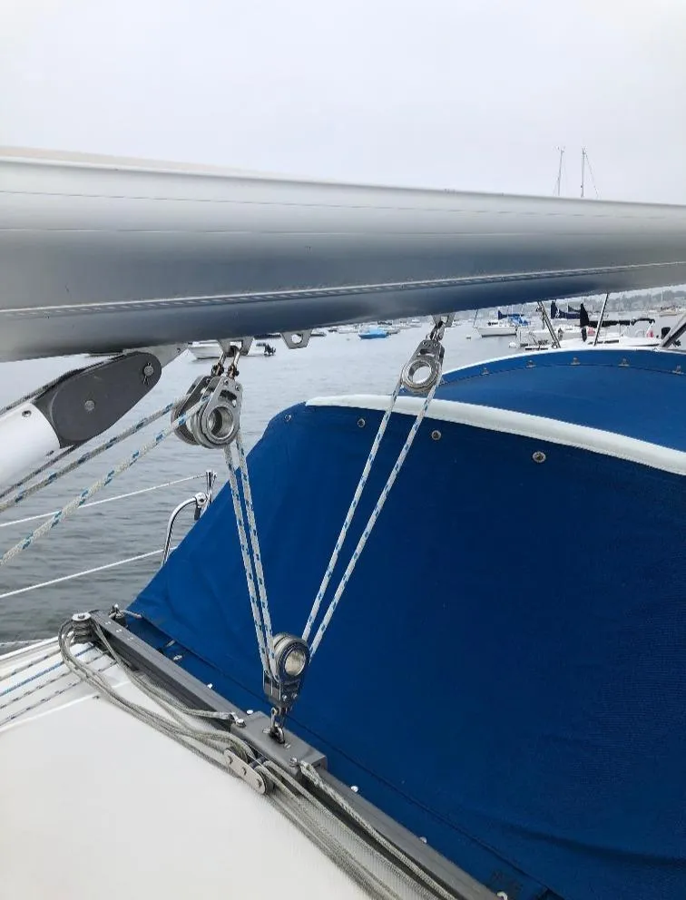 Slide: The Image of 1998 Catalina 320 sailboat with blue cover in harbor. - 14