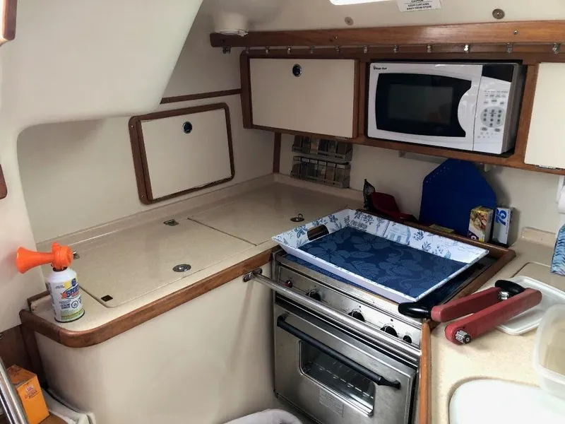 Slide: The Image of 1998 Catalina 320 yacht kitchen with stove and microwave. - 17