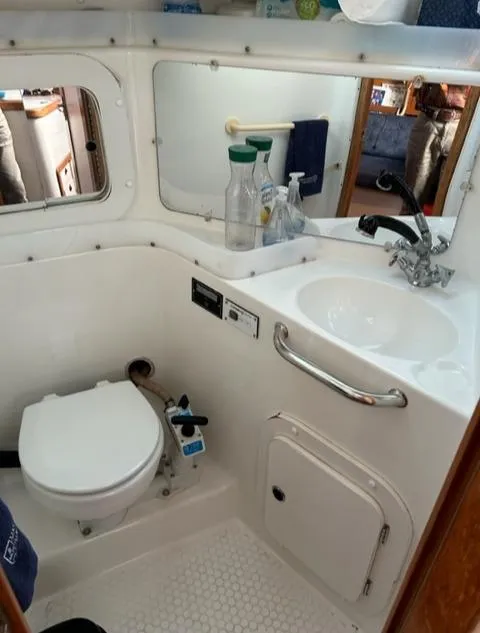 Slide: The Image of Interior view of a 1998 Catalina 320 boat bathroom. - 20
