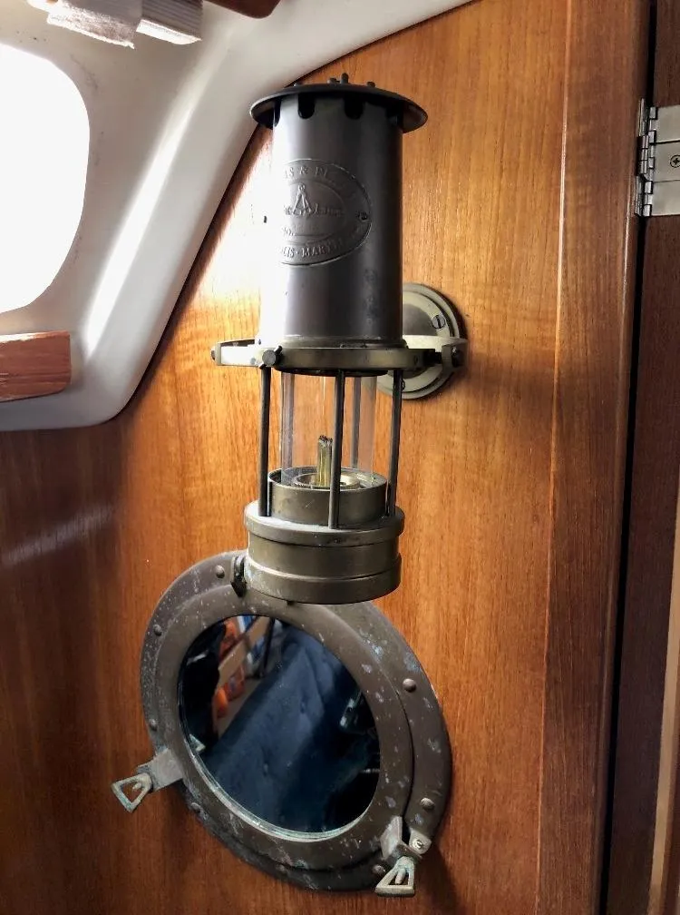 Slide: The Image of Interior of a Catalina 320 yacht with antique lamp and porthole. - 24