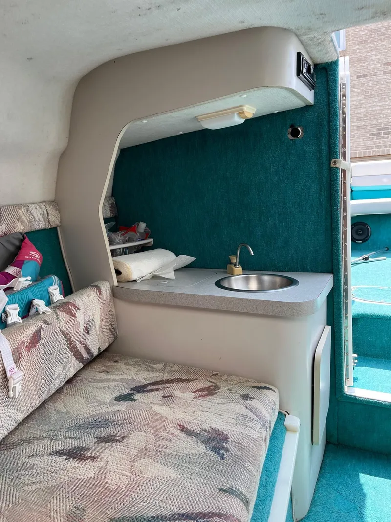 Slide: The Image of Interior of 1993 Chris-Craft 238 Concept boat with kitchenette and seating area. - 11