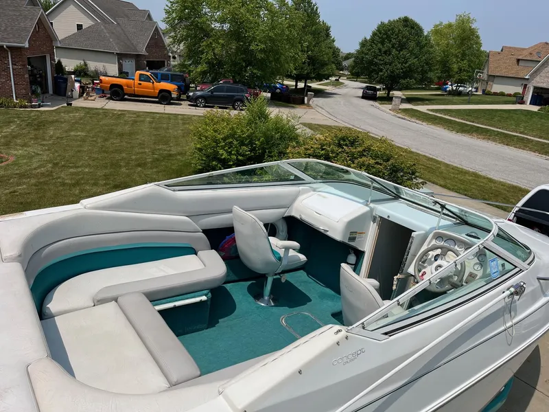 Slide: The Image of 1993 Chris-Craft 238 Concept boat with white and teal interior in a suburban neighborhood. - 17