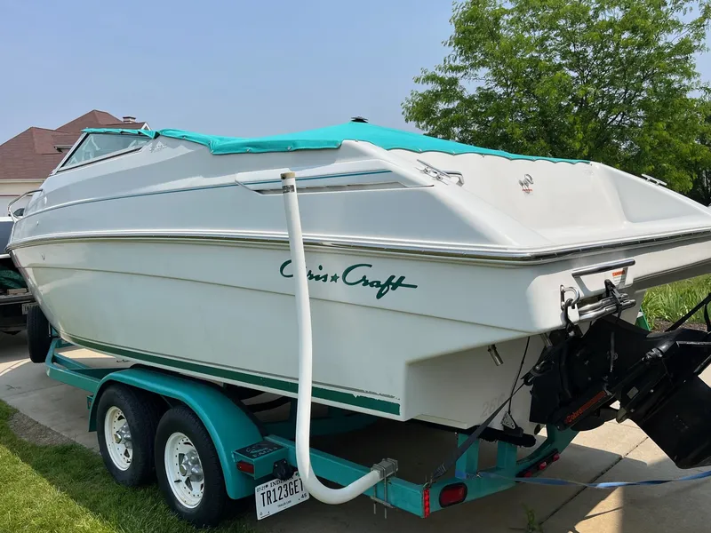 Slide: The Image of 1993 Chris-Craft 238 Concept boat on a trailer in a driveway. - 23