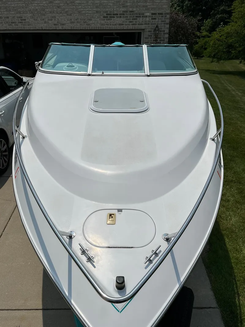 Slide: The Image of 1993 Chris-Craft 238 Concept boat, white exterior, docked on a driveway. - 25