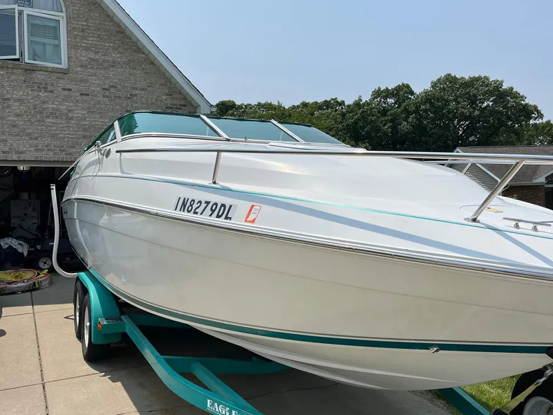 Slide: The Image of 1993 Chris-Craft 238 Concept boat on trailer in driveway. - 27