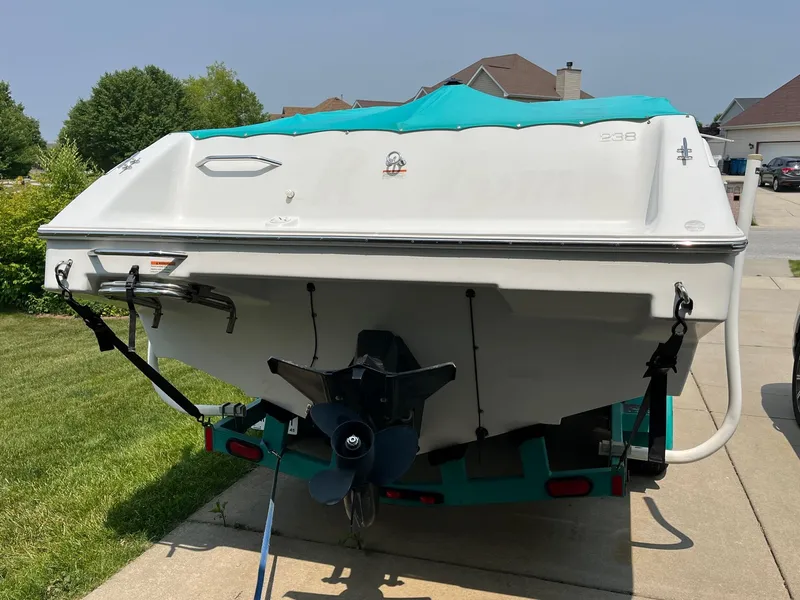 Slide: The Image of 1993 Chris-Craft 238 Concept boat on trailer in residential driveway. - 30