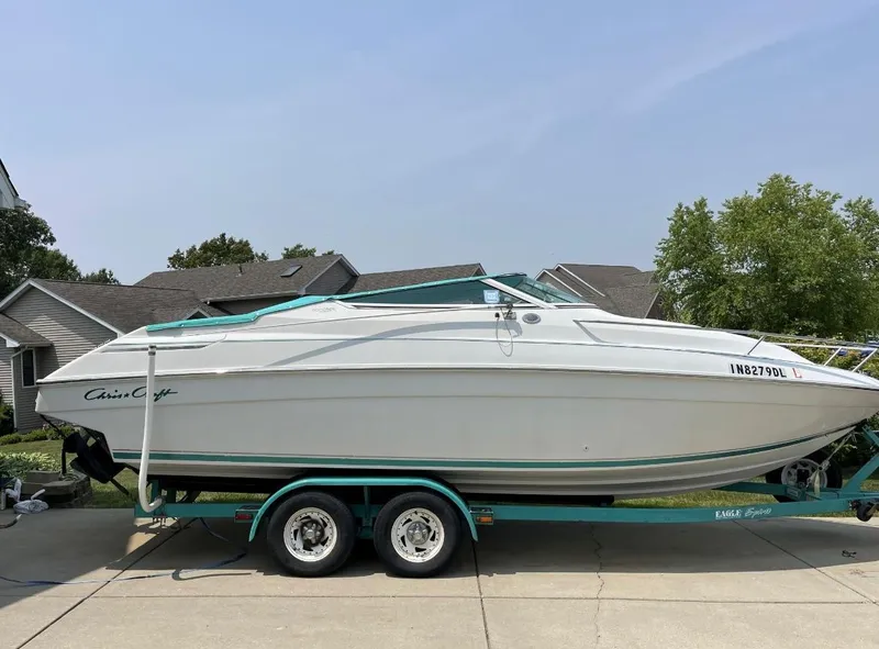 Slide: The Image of 1993 Chris-Craft 238 Concept boat on a trailer in a residential driveway. - 31