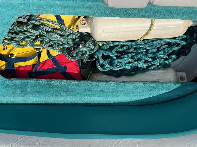 Slide: The Image of Storage compartment of a 1993 Chris-Craft 238 Concept boat with ropes and gear. - 5