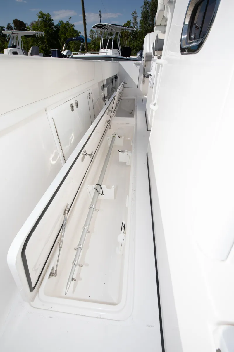 Slide: The Image of 2024 Edgewater 340CC boat with open storage compartment on deck. - 12