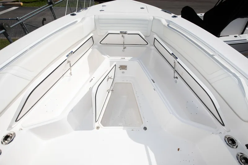 Slide: The Image of 2024 Edgewater 340CC boat interior with open storage compartments. - 13