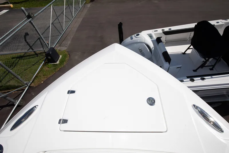 Slide: The Image of 2024 Edgewater 340CC boat bow view with storage hatch. - 17