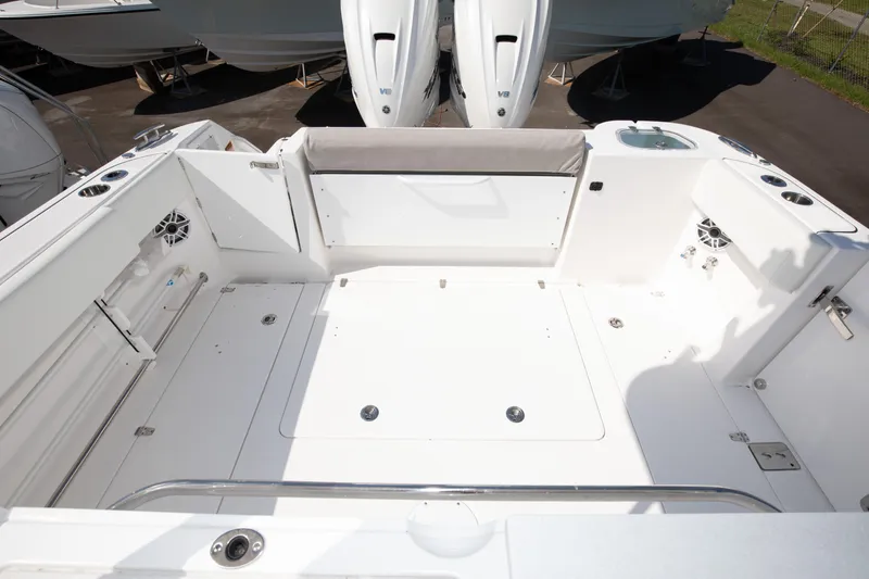 Slide: The Image of 2024 Edgewater 340CC boat deck with seating and storage compartments. - 2