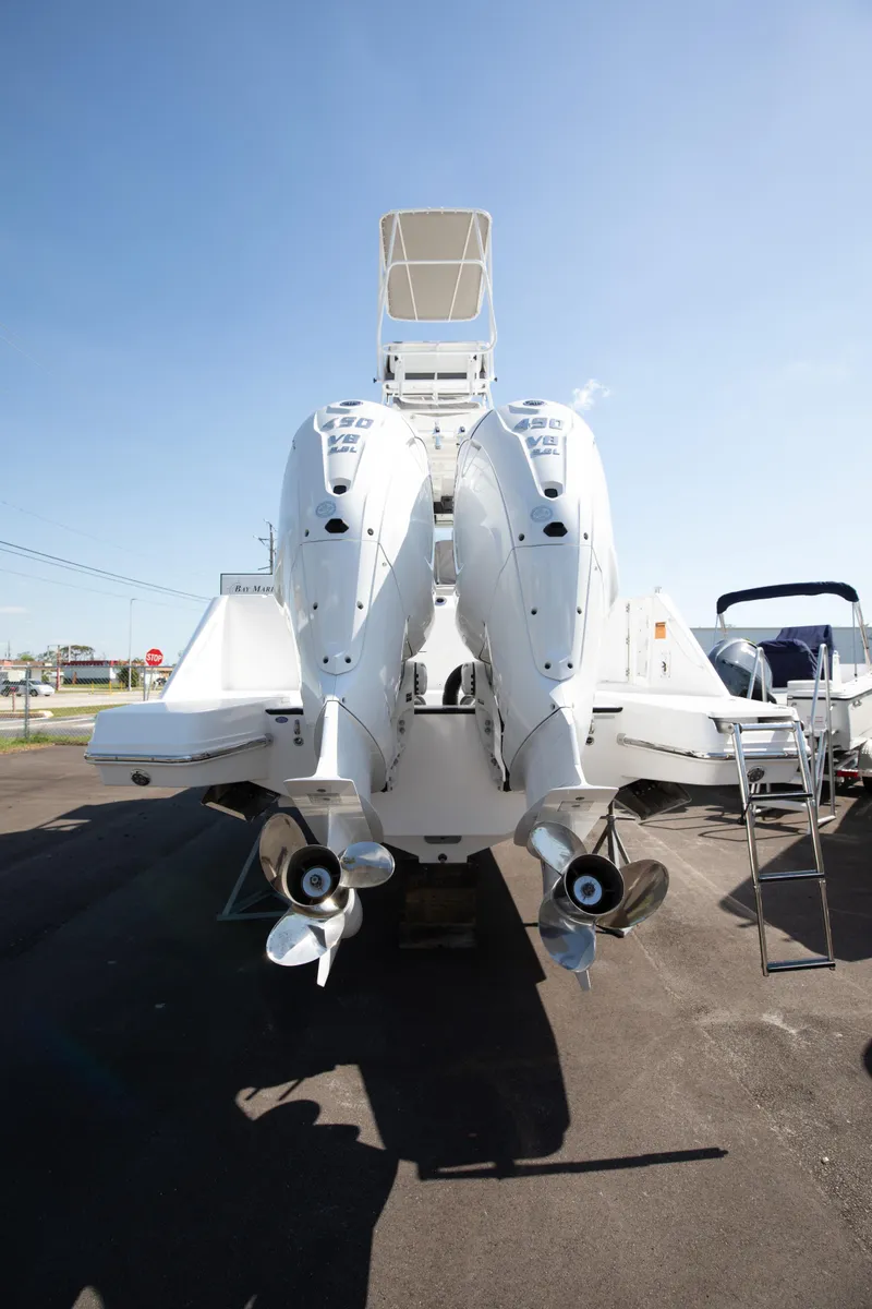 Slide: The Image of 2024 Edgewater 340CC boat with twin outboard engines, rear view. - 24