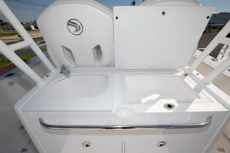 Slide: The Image of 2024 Edgewater 340CC boat sink and storage area. - 26