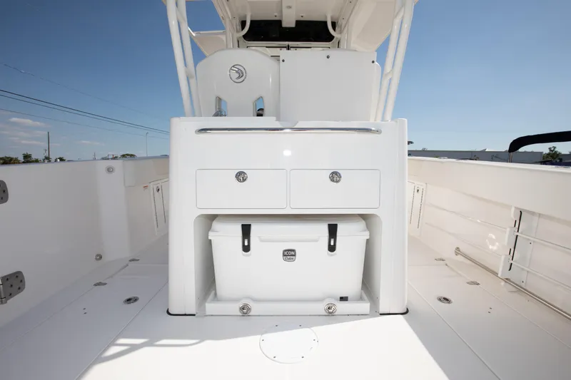 Slide: The Image of 2024 Edgewater 340CC boat interior with storage compartments and cooler. - 27