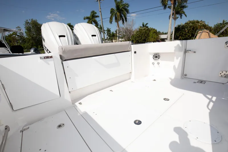 Slide: The Image of 2024 Edgewater 340CC boat deck with twin outboard engines and seating. - 29