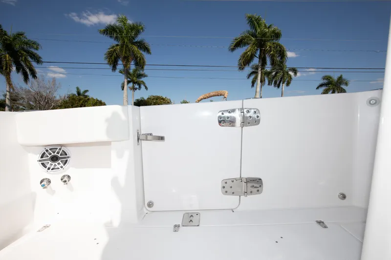 Slide: The Image of 2024 Edgewater 340CC boat interior with palm trees in the background. - 30