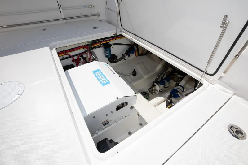 Slide: The Image of 2024 Edgewater 340CC boat engine compartment with open hatch. - 31