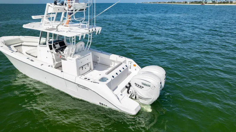 Slide: The Image of 2024 Edgewater 340CC boat on open water with Yamaha engines. - 4
