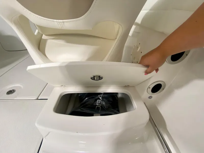 Slide: The Image of 2024 Robalo R207 Dual Console storage compartment under seat. - 11