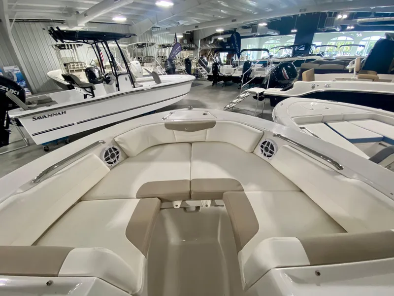 Slide: The Image of 2024 Robalo R207 Dual Console boat interior in showroom. - 24