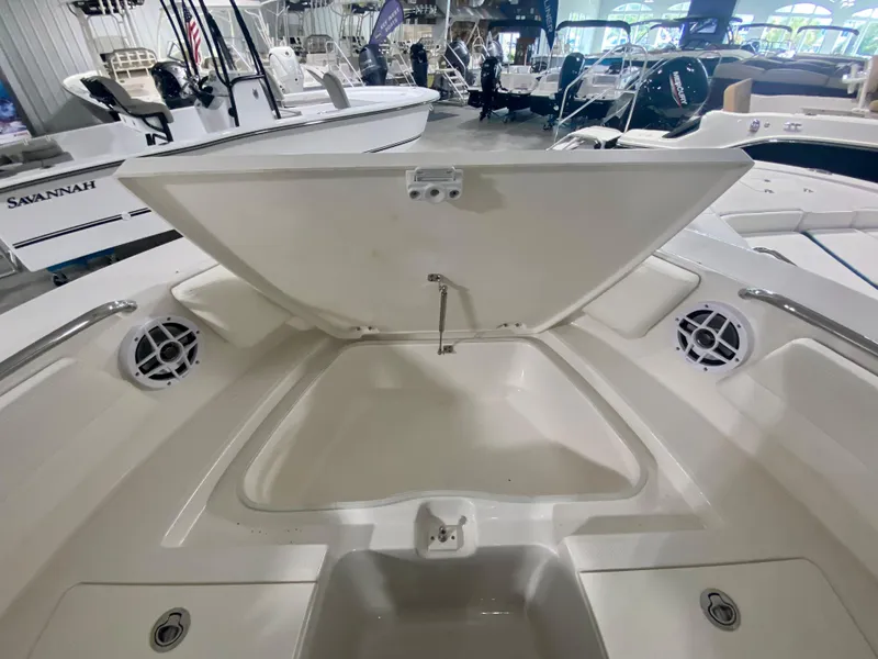 Slide: The Image of 2024 Robalo R207 Dual Console boat with open storage compartment. - 27