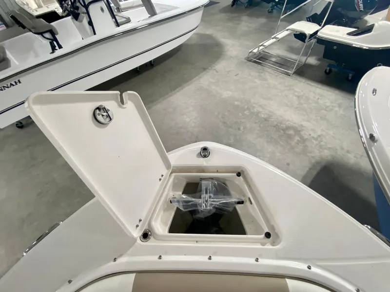Slide: The Image of 2024 Robalo R207 Dual Console boat with open storage compartment. - 28