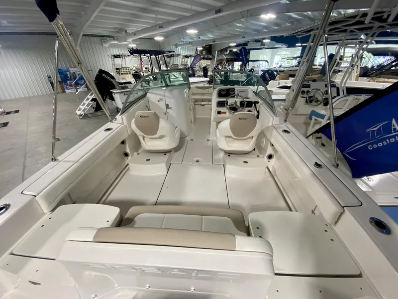Slide: The Image of 2024 Robalo R207 Dual Console boat interior in showroom. - 4