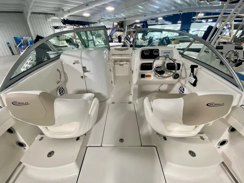 Slide: The Image of 2024 Robalo R207 Dual Console boat interior with helm and seating. - 8