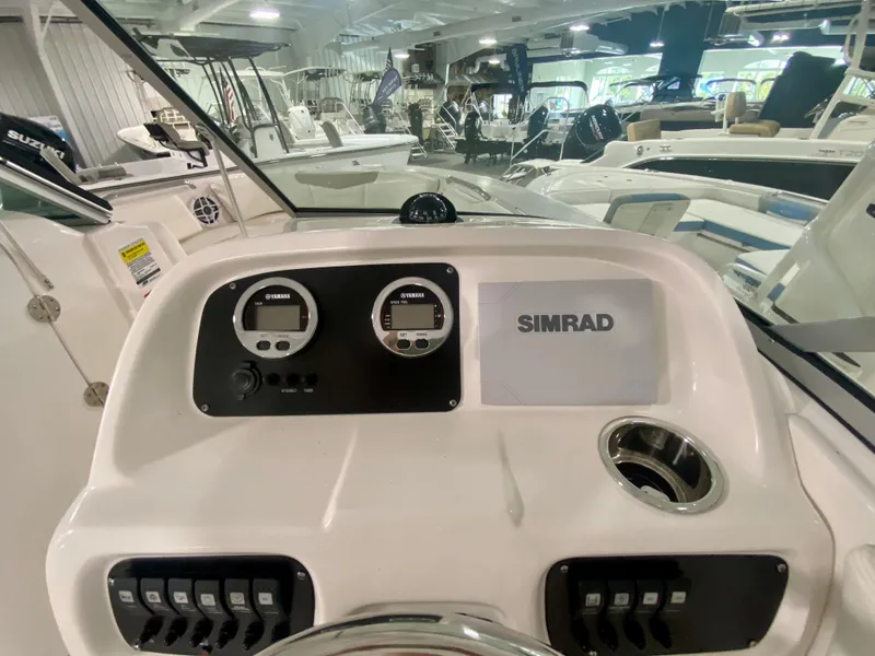 Slide: The Image of 2024 Robalo R207 Dual Console boat dashboard with Simrad electronics in a showroom. - 20