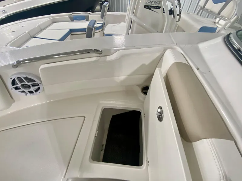 Slide: The Image of 2024 Robalo R207 Dual Console boat interior with storage compartment and seating. - 29
