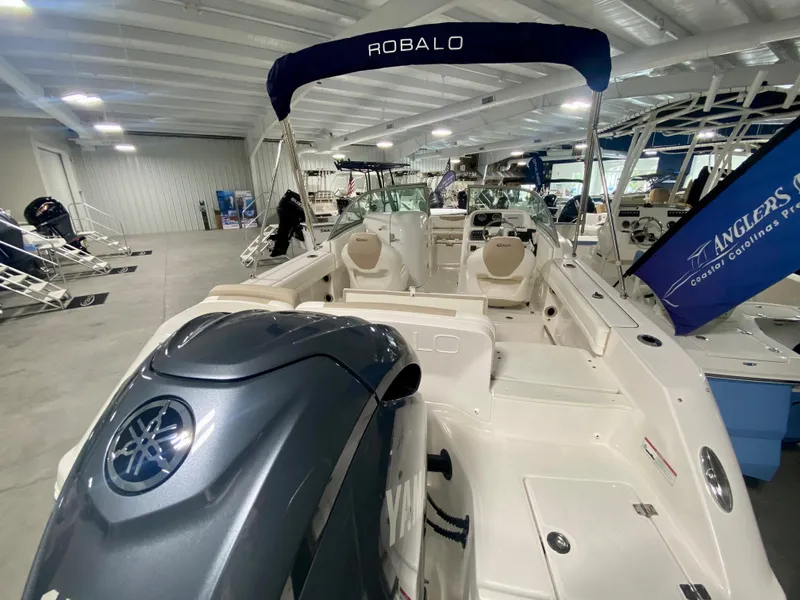 Slide: The Image of 2024 Robalo R207 Dual Console boat with Yamaha outboard engine in showroom. - 3