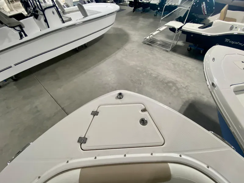 Slide: The Image of 2024 Robalo R207 Dual Console boat bow in showroom. - 30