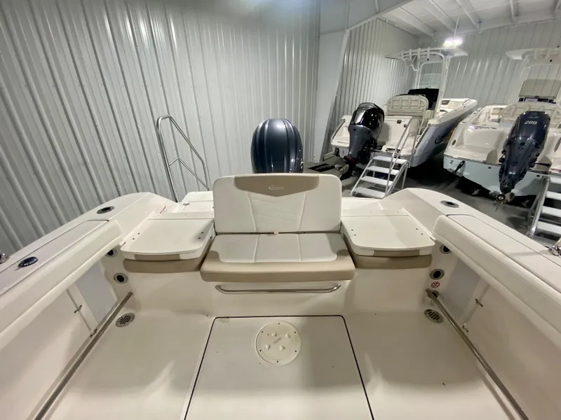 Slide: The Image of 2024 Robalo R207 Dual Console boat interior with seating and outboard motor. - 5